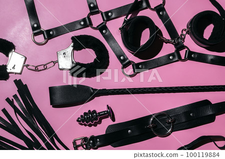 Handcuffs, whip flogger for BDSM sex with submission and domination. A set of adult intimate erotic sex toys 100119884
