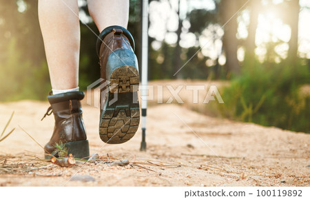 Hiking, walking and active feet closeup of an outdoors hike, walk and adventure on a mountain trail. Relaxing, freedom and carefree activity outside in nature on a sunny summer day in the mountains Hiking, walking and active feet closeup of an outdoors hike, walk and adventure on a mountain trail. Relaxing, freedom and carefree activity outside in nature on a sunny summer day in the mountains 100119892