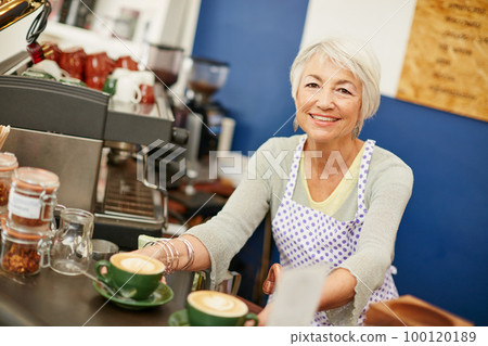 Forget the rest, our coffees the best. Shot of a senior woman serving coffee in a cafe. Forget the rest, our coffees the best. Shot of a senior woman serving coffee in a cafe. 100120189