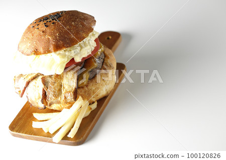 BLT 漢堡，上面放著塔塔醬，培根、生菜和番茄夾在土豆和白色背景之間 100120826