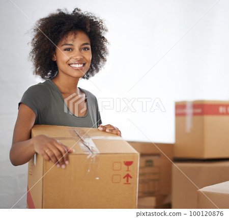 Heres to a new start. Shot of a young woman moving into her new house. 100120876