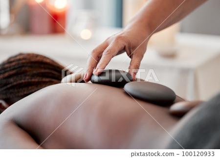 Hot stone massage, spa and hand of masseuse, holistic care and wellness with black woman and treatment. Health, peace of mind and self care with zen, stress relief for people and back skin detox Hot stone massage, spa and hand of masseuse, holistic care and wellness with black woman and treatment. Health, peace of mind and self care with zen, stress relief for people and back skin detox 100120933