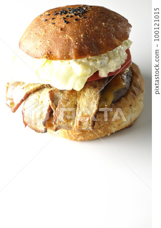 A BLT burger with tartar sauce protruding and bacon, lettuce and tomato sandwiched in a white background 100121015