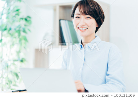 Middle woman teleworking in the living room Middle woman teleworking in the living room 100121109
