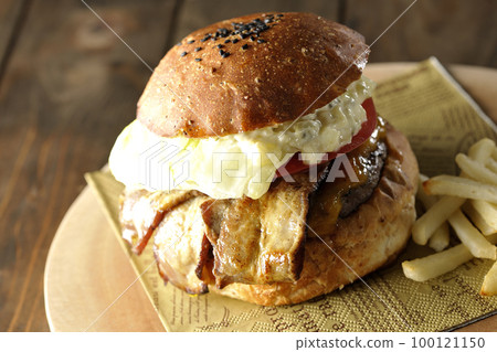 BLT Burger with tartar sauce protruding and bacon, lettuce and tomato sandwiched between fries 100121150