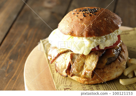 BLT Burger with tartar sauce protruding and bacon, lettuce and tomato sandwiched between fries 100121153