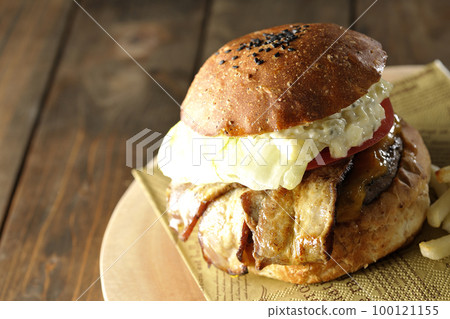 BLT Burger with tartar sauce protruding and bacon, lettuce and tomato sandwiched between fries 100121155