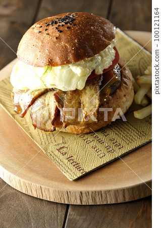 BLT Burger with tartar sauce protruding and bacon, lettuce and tomato sandwiched between fries 100121164