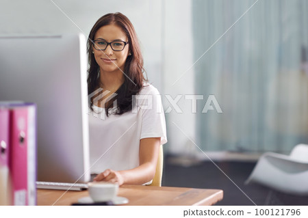 Shes an asset to the company. Cropped portrait of an attractive young businesswoman working at her desk. Shes an asset to the company. Cropped portrait of an attractive young businesswoman working at her desk. 100121796