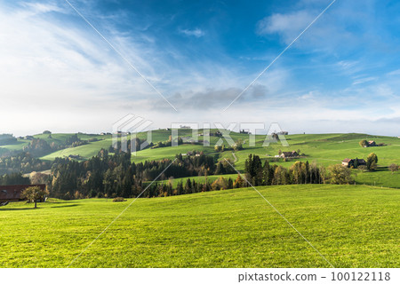 Hilly landscape with farmhouses and green meadows in Switzerland Hilly landscape with farmhouses and green meadows in Switzerland 100122118