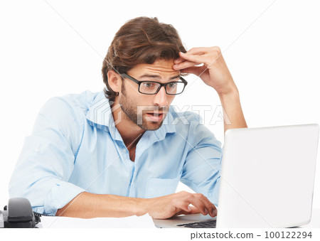 Shock, surprise and businessman on a laptop working on a project with a deadline in a studio. Shocked, wow and professional male employee gasping while doing research on computer by white background. 100122294