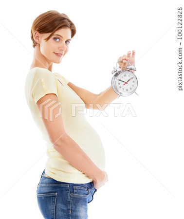 Pregnancy, clock and portrait of woman in studio holding her stomach waiting for birth of her baby. Maternity, prenatal and pregnant girl model with alarm clock for time isolated by white background. 100122828