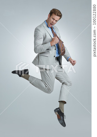 Oh yeah. Shot of a young businessman wildly celebrating his success. 100122880