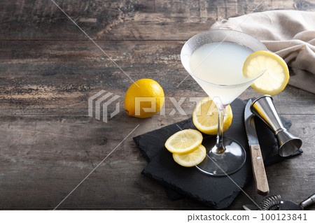 Lemon drop martini cocktail on wooden table 100123841