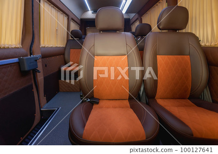 Comfortable interior of a passenger bus with soft seats Comfortable interior of a passenger bus with soft seats 100127641
