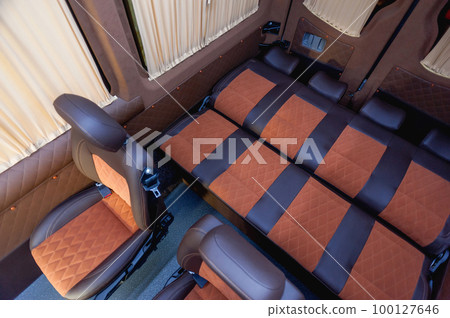 Comfortable interior of a passenger bus with soft seats Comfortable interior of a passenger bus with soft seats 100127646