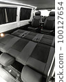 Comfortable interior of a passenger bus with soft seats 100127654