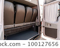 Comfortable interior of a passenger bus with soft seats 100127656