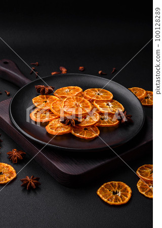 Dried round shape slices of bright orange color tangerine Dried round shape slices of bright orange color tangerine 100128289