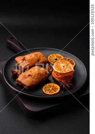 Delicious chocolate muffins and dried round shaped slices of tangerine Delicious chocolate muffins and dried round shaped slices of tangerine 100128328