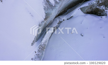 A huge ice wall from a glacier in the mountains. A huge ice wall from a glacier in the mountains. 100129820