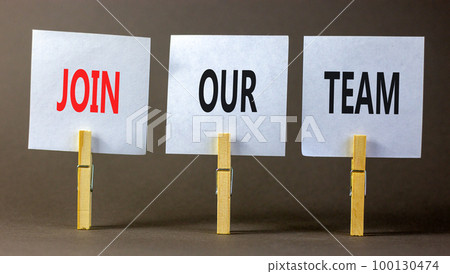 Join our team symbol. Concept words Join our team on white paper on wooden clothespin on a beautiful grey table grey background. Business and join our team concept. Copy space. 100130474