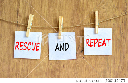 Rescue and repeat symbol. Concept words Rescue and repeat on white paper on wooden clothespin on a beautiful wooden table wooden background. Business rescue and repeat concept. Copy space. 100130475