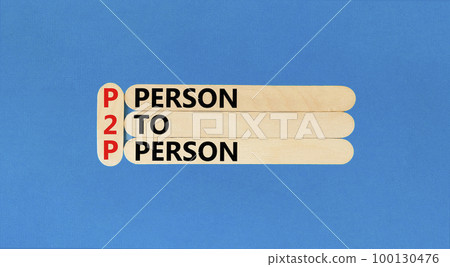P2P person to person symbol. Concept words P2P person to person on wooden stick on a beautiful blue table blue background. Business and P2P person to person concept. Copy space. P2P person to person symbol. Concept words P2P person to person on wooden stick on a beautiful blue table blue background. Business and P2P person to person concept. Copy space. 100130476