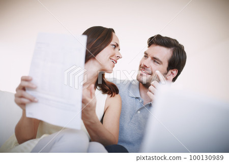 Were right on track. Low-angle view of a young couple animatedly discussing their home finances. Were right on track. Low-angle view of a young couple animatedly discussing their home finances. 100130989
