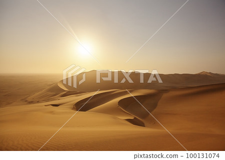 Dune Sunset. High angle shot of a sunset over the sand dunes in the Namibian Desert. 100131074