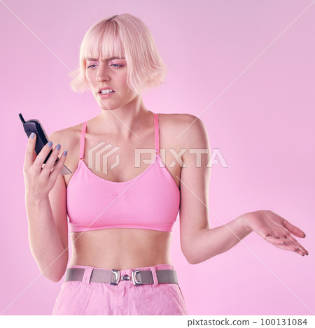 Retro phone, fashion and woman with glitch on pink background with network issue, problem or spam. Creative aesthetic, beauty and confused girl with vintage cellphone, makeup and cosmetics in studio 100131084