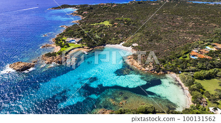 Italy summer holidyas . Sardegna island - stunning Emerald coast (Costa Smeralda) with beautiful beaches. aerial view of small Romazzino beach . Italy summer holidyas . Sardegna island - stunning Emerald coast (Costa Smeralda) with beautiful beaches. aerial view of small Romazzino beach . 100131562