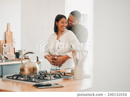 Loving, happy and hugging couple relaxing in the kitchen at home smiling and laughing together. Carefree, excited and affectionate lovers having fun and enjoying quality time in the house Loving, happy and hugging couple relaxing in the kitchen at home smiling and laughing together. Carefree, excited and affectionate lovers having fun and enjoying quality time in the house 100132016