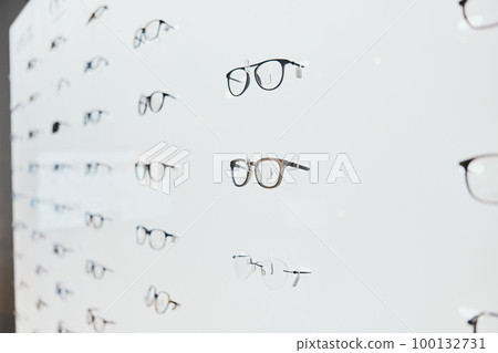 Glasses, frame choice and retail sale in a healthcare, eye wellness and wellness store with no people. Shop stock, eyewear and consumer products on a display stand for shopping and buying in market Glasses, frame choice and retail sale in a healthcare, eye wellness and wellness store with no people. Shop stock, eyewear and consumer products on a display stand for shopping and buying in market 100132731