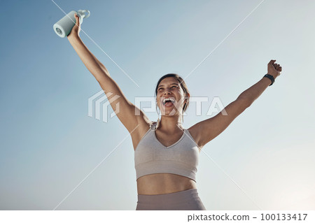 Fitness success, blue sky and woman arms in air with water bottle outdoor. Excited, happy smile and athlete with sports feeling freedom from motivation and happiness with exercise target goal Fitness success, blue sky and woman arms in air with water bottle outdoor. Excited, happy smile and athlete with sports feeling freedom from motivation and happiness with exercise target goal 100133417