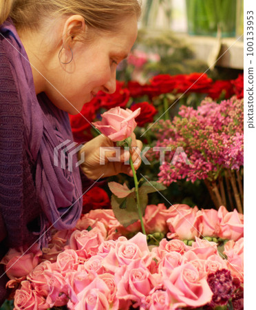 Woman, smelling roses and retail for floral bouquet for scent, color and shopping for valentines day gift. Flowers, leaves and sustainable plants for beauty, present and sale in startup florist store 100133953