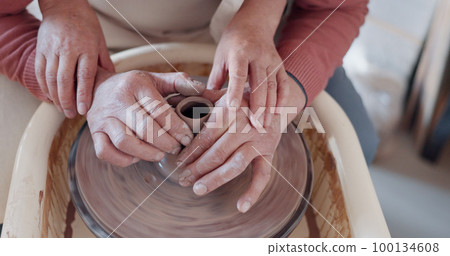Love, pottery and hands of old couple molding in workshop studio for creative art, support and ceramics class. Trust, marriage and retirement with man and woman with clay wheel on crafting date Love, pottery and hands of old couple molding in workshop studio for creative art, support and ceramics class. Trust, marriage and retirement with man and woman with clay wheel on crafting date 100134608