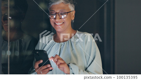 Smartphone, night and senior business woman on mobile app for global networking, funny meme or social media. Happy corporate worker using phone or cellphone in dark office for digital communication 100135395