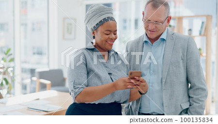 Woman, phone and businessman for social media, laughing and funny meme in finance office. Happy senior executive, black woman and smartphone for joke, social network or conversation on lunch at work Woman, phone and businessman for social media, laughing and funny meme in finance office. Happy senior executive, black woman and smartphone for joke, social network or conversation on lunch at work 100135834