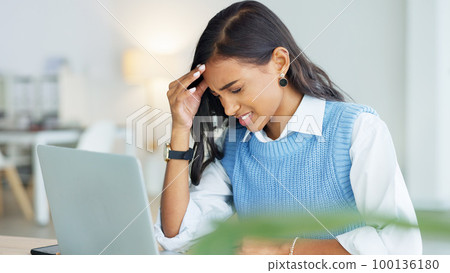 An overworked business woman with a headache while working in her office. A tired or stressed corporate female in pain at the workplace. A young entrepreneur suffering from fatigue An overworked business woman with a headache while working in her office. A tired or stressed corporate female in pain at the workplace. A young entrepreneur suffering from fatigue 100136180