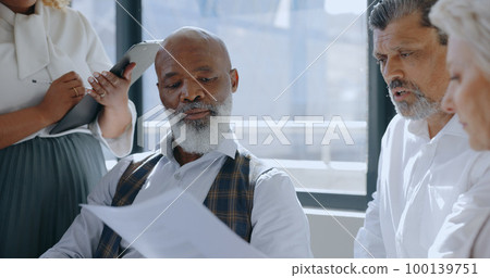 Teamwork, documents and business people in meeting in office discussing sales project. Paperwork, leadership and group of employees brainstorming ideas, planning marketing or advertising strategy. 100139751
