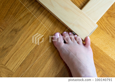 Woman hit furniture with the little toe. Incident at home. Injury of foot little finger Woman hit furniture with the little toe. Incident at home. Injury of foot little finger 100140791