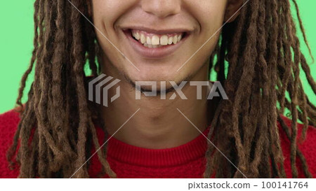 Laughing, smile and mouth of a man for a joke on a green screen isolated on studio background. Happy, comedy and zoom of a guy showing teeth for dental care, happiness and healthcare on a backdrop 100141764