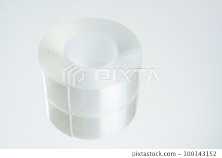 a roll of adhesive transparent tape on a white background.  100143152