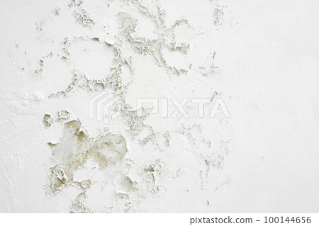 Closeup of badly fixed building facade wall covered with cracks in stucco and paint. Closeup of badly fixed building facade wall covered with cracks in stucco and paint. 100144656