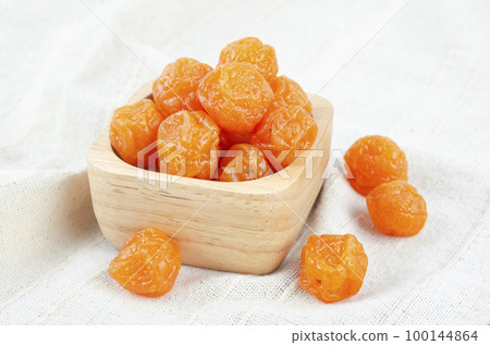 The Delicious dried small yellow plums (mirabelles). Shallow depth of field. The Delicious dried small yellow plums (mirabelles). Shallow depth of field. 100144864