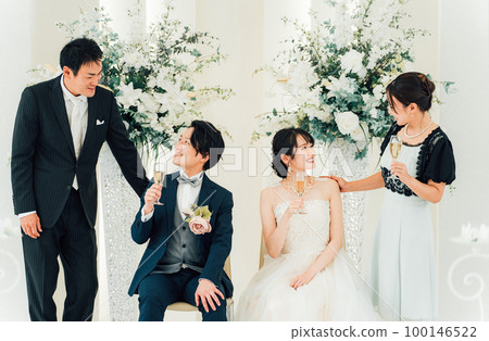 Bride and groom talking at a wedding reception with family, friends, relatives (Asian, Japanese, Chinese, Korean) 100146522