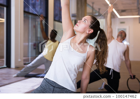 Young sporty woman exercising with pilates circle 100147462