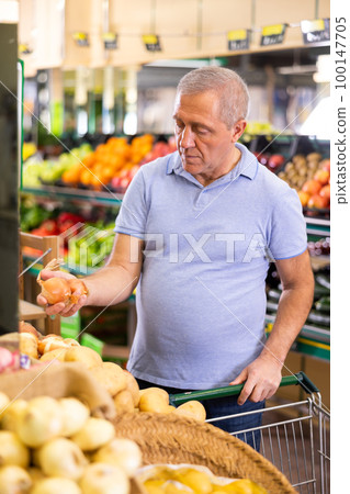 man buy large onion in supermarket man buy large onion in supermarket 100147705