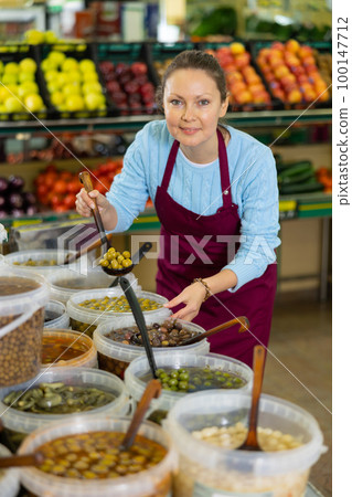 woman seller offers to buy olives woman seller offers to buy olives 100147712